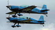 The Blades Extra EA-300L (G-ZEXL) at  Farnborough, United Kingdom